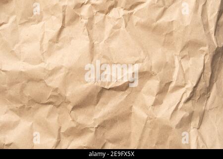 Crumpled brown paper texture perfect for background structure. Packaging material with rough wrinkles. The grunge textured surface is vintage Stock Photo