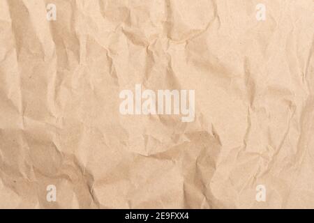 Crumpled brown paper texture perfect for background structure. Packaging material with rough wrinkles. The grunge textured surface is vintage Stock Photo
