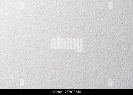 Ingrain wallpaper in white used in a German apartment on a wall. Blank white texture indoors mit a pattern caused by little wood chips Stock Photo