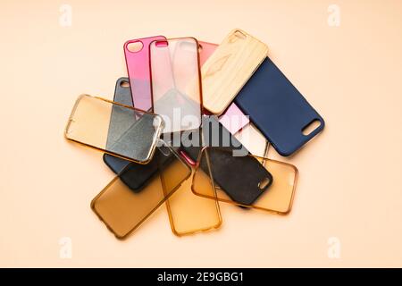 Pile of multicolored plastic back covers for mobile phones on neutral background Stock Photo