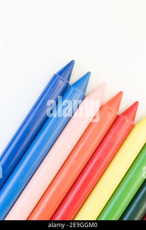 Vertical top view of wax crayons isolated on a white background Stock Photo