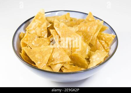 High angle shot of a bowl full of nachos on an isolated white surface Stock Photo