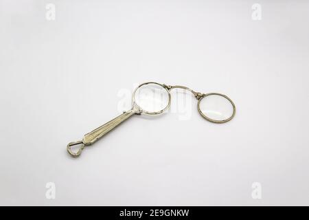 Old vintage lorgnette from the middle of the nineteenth century on the white background Stock Photo