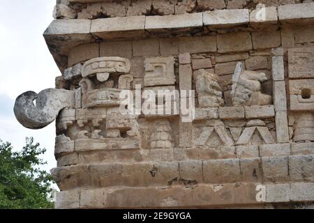 Stone sculpture of rain god Chac with curly nose on the corner of temple building at Chichen Itza, Yucatan, Mexico Stock Photo