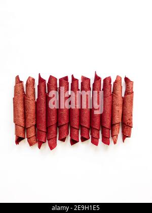 Red fruit leather rolls isolated on white. Fruit candy - pastille. Top view Stock Photo