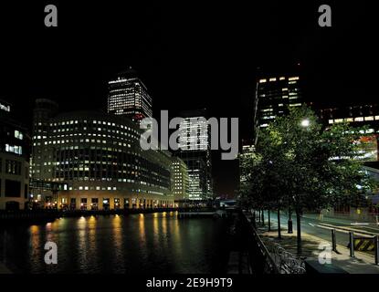 View From Bank Street To The Middle Dock And The Brightly Lit Bank Towers In Canary Wharf London England At Night Stock Photo