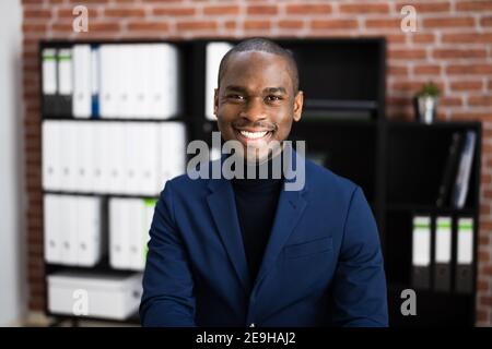 Happy Professional African American Employee In Office Stock Photo