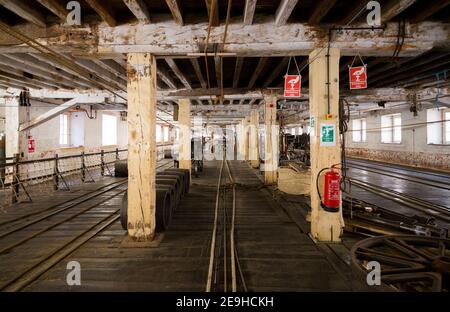 Long view inside the ropery at the Historic Dockyard / Dockyards Chatham in Kent. The ropewalk at Chatham Dockyard (as part of the Ropery or Ropehouse) is still producing rope commercially after several hundred years. England UK (121) Stock Photo