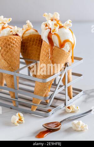 Close-up of delicious salted caramel popcorn ice cream cones on white background Stock Photo