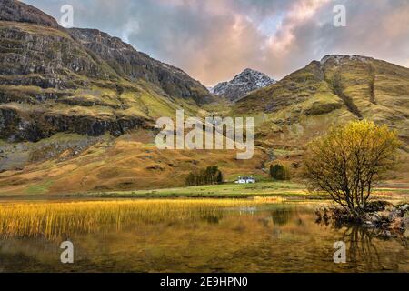 Glen Coe, Scotland: Solitary house in the Scottish Highlands along the river Coe in evening light