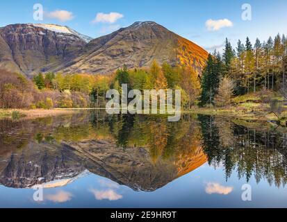 Glencoe, Scotland: A small pond with fall reflections and the mountains of Glen Coe at sunset