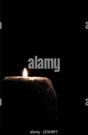 big candle burning in dark Stock Photo