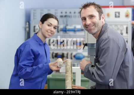 apprentice working with engineer on cnc machinery Stock Photo
