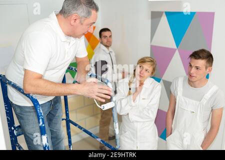 portrait of a painter with apprentices Stock Photo