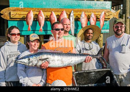 Alabama Orange Beach Zeke's Landing Red Snapper Tournament,caught wahoo fish holding team men women Black man, Stock Photo