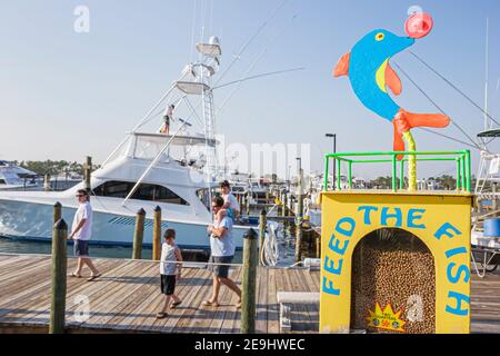 Alabama Orange Beach Zeke's Landing fish feed vending machine,Cotton Bayou charter fishing boat, Stock Photo