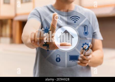 Man using application of smart home automation outdoors Stock Photo