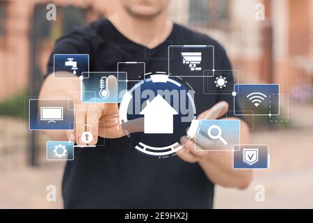 Man using application of smart home automation outdoors Stock Photo