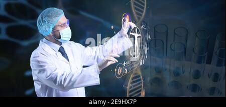 Young doctor using virtual screen on dark background Stock Photo