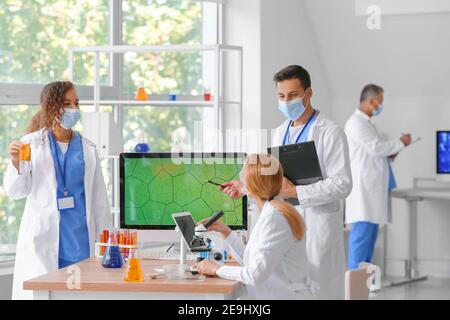 Group of scientists working in laboratory Stock Photo