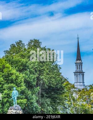 Lexington Minute Man Patriot Statue First Parish Church Spire Lexington Battle Green Massachusetts.  Site of April 19, 1775 first battle of American R Stock Photo