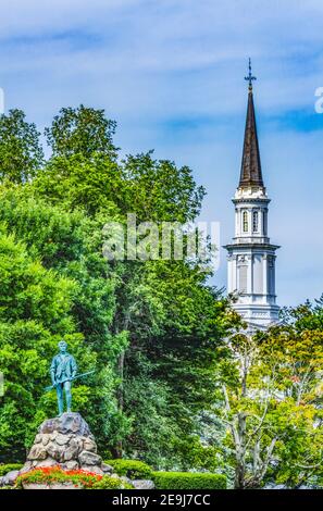 Lexington Minute Man Patriot Statue First Parish Church Spire Lexington Battle Green Massachusetts.  Site of April 19, 1775 first battle of American R Stock Photo