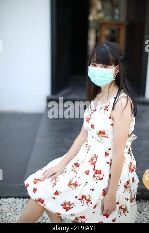 Portrait young woman with mask at urban outdoor Stock Photo
