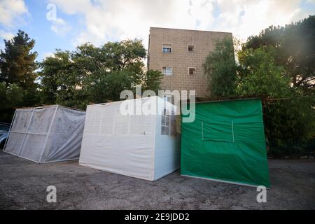 Three Sukkot placed on the road during the Jewish holiday called Sukkot, Jerusalem, Israel. Stock Photo