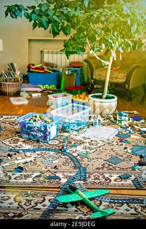 Games floor for preschoolers kindergarten. interior children's room. mess in the room. mess in the children's room, scattered toys, boxes on the floor Stock Photo