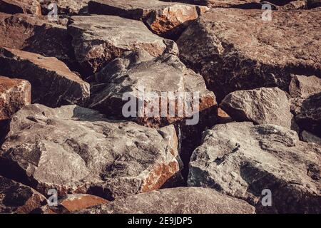 View of big granite rocks layered over beach sand along kovalam beach, Chennai, India Stock Photo