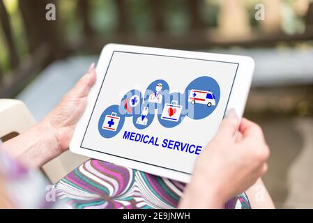 Medical service concept shown on a tablet held by a woman Stock Photo