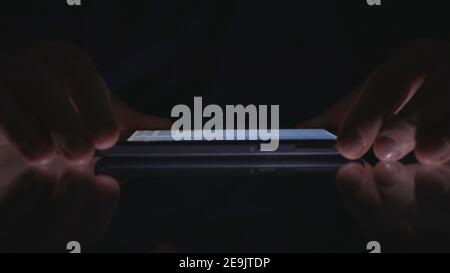 Night Shoot with a Businessman Using Cell Phone Communication. Man Text on a Smartphone. Stock Photo