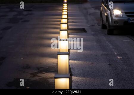Street Lights in the Middle of Photo With Car Passing in Background .Early Night And Details in the Dark are Still Visible. On Europe Square in Nova G Stock Photo