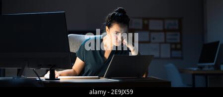 Late Night Workaholic Busy Business Woman At Computer Stock Photo