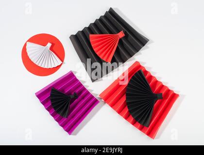 Origami paper fans on zigzag fold paper. Top view. Stock Photo