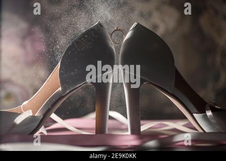 Bride's engagement ring on wedding day with beautiful holiday shoes Stock Photo