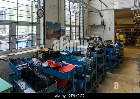 nside the shoe factory of NPS Ltd, a British shoe maker, Wollaston, Northamptonshire, UK; machinery on the factory floor. Stock Photo