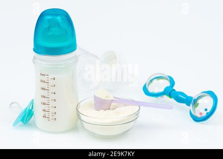 Composition with feeding bottle of baby milk formula on white table. Baby food concept Stock Photo