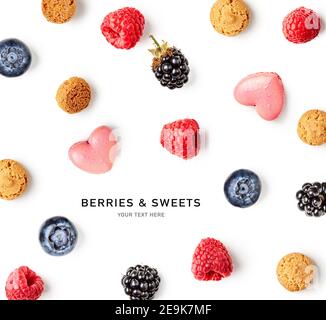Almond cookies, raspberry, blackberry, blueberry and macaroons creative pattern on white background. Sweets and fruits composition and collection. Foo Stock Photo