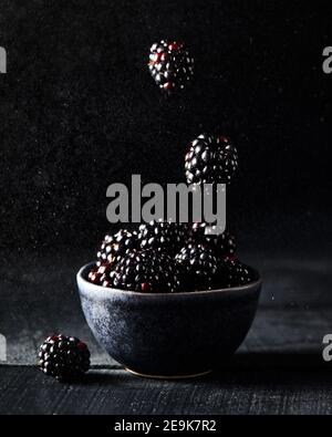 Fresh blackberry levitation on dark black background close up Stock Photo