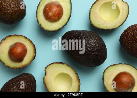Ripe avocado on blue background, top view Stock Photo