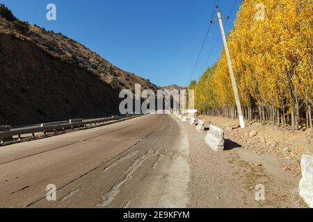 highway A 373, Tashkent Osh highway, Kamchik pass, Uzbekistan. mountain road in autumn. Stock Photo