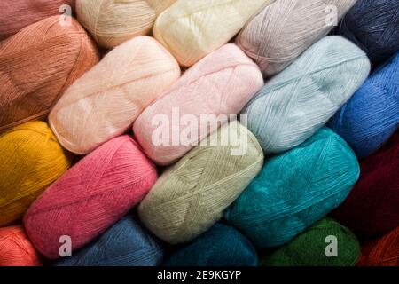 The set of bundles of multicolored threads for knitting as a background Stock Photo