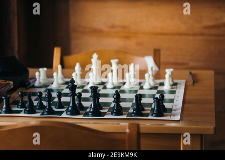 Chess board on indoor wooden table Stock Photo