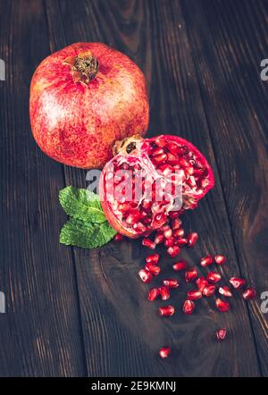 Fresh pomegranate on the wooden table: cross section Stock Photo