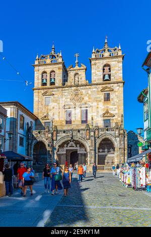 BRAGA, PORTUGAL, MAY 22, 2019: People are strolling on a street leading to the old cathedral in the historical center of Braga, Portugal Stock Photo