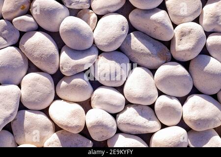 White pebbles in a random order. Costa Adeje. Tenerife. Spain. Stock Photo