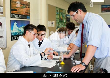 teenage students in a science class being instructing by a teacher Stock Photo
