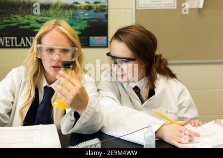 Two teenage female students performing a science experiment Stock Photo