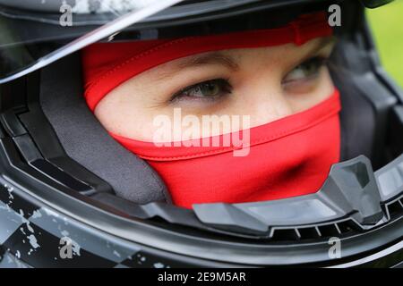 Symbol image: Female race car driver wearing helmet and balaclava (model released) Stock Photo